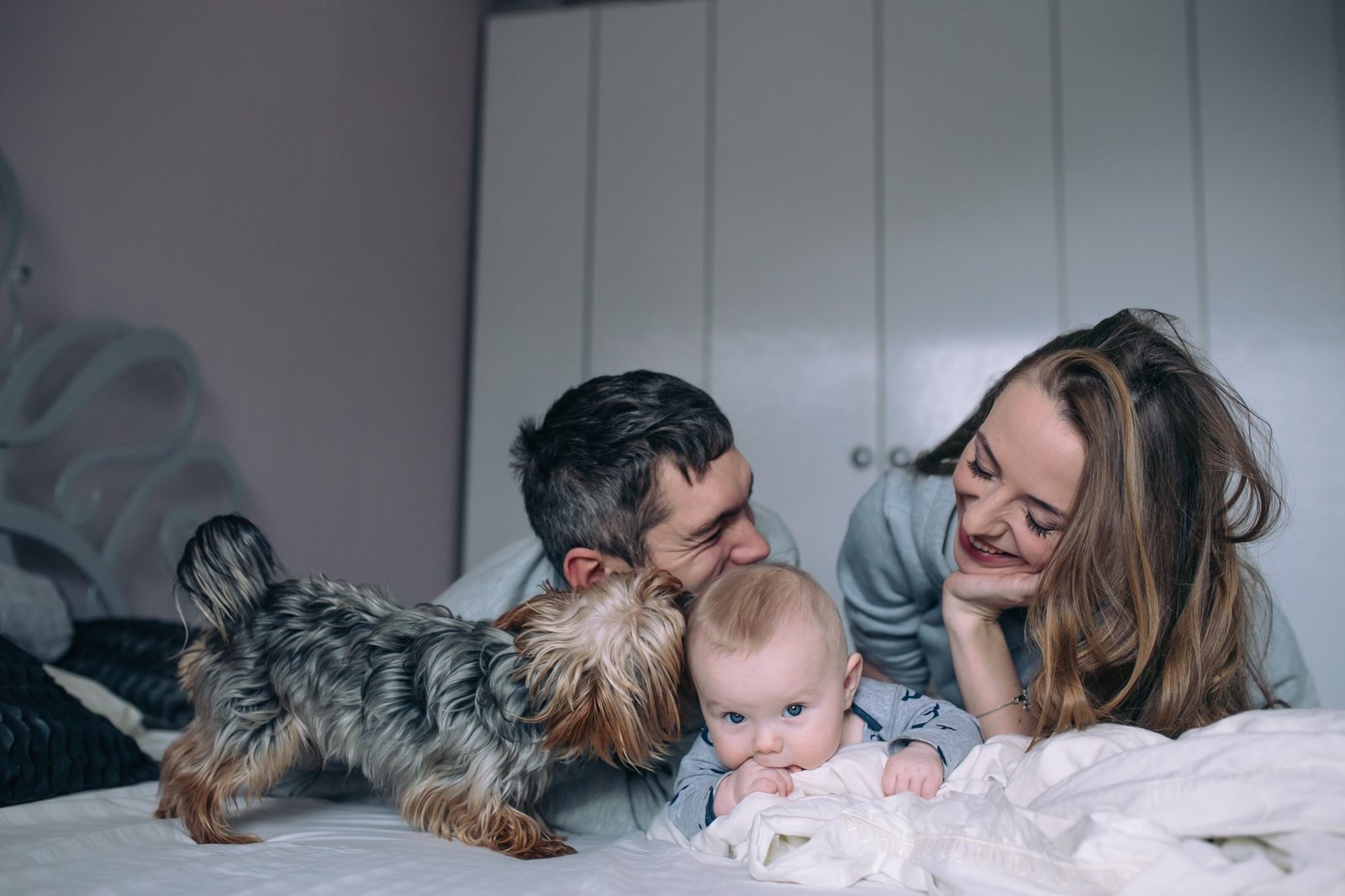 Family playing on bed in the bedroom